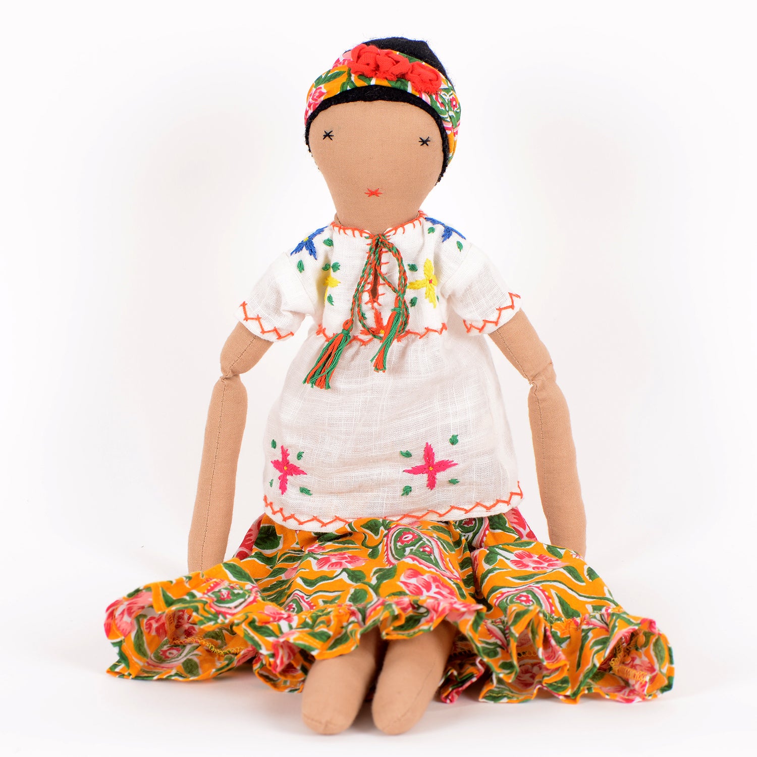 Frida, a handcrafted Afghan doll with vibrant floral patterns and intricate embroidery, symbolizing resilience and empowerment.